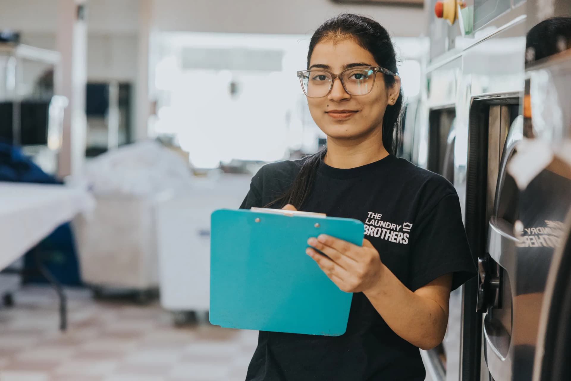A Laundry Brothers team member smiling confidently in the facility.