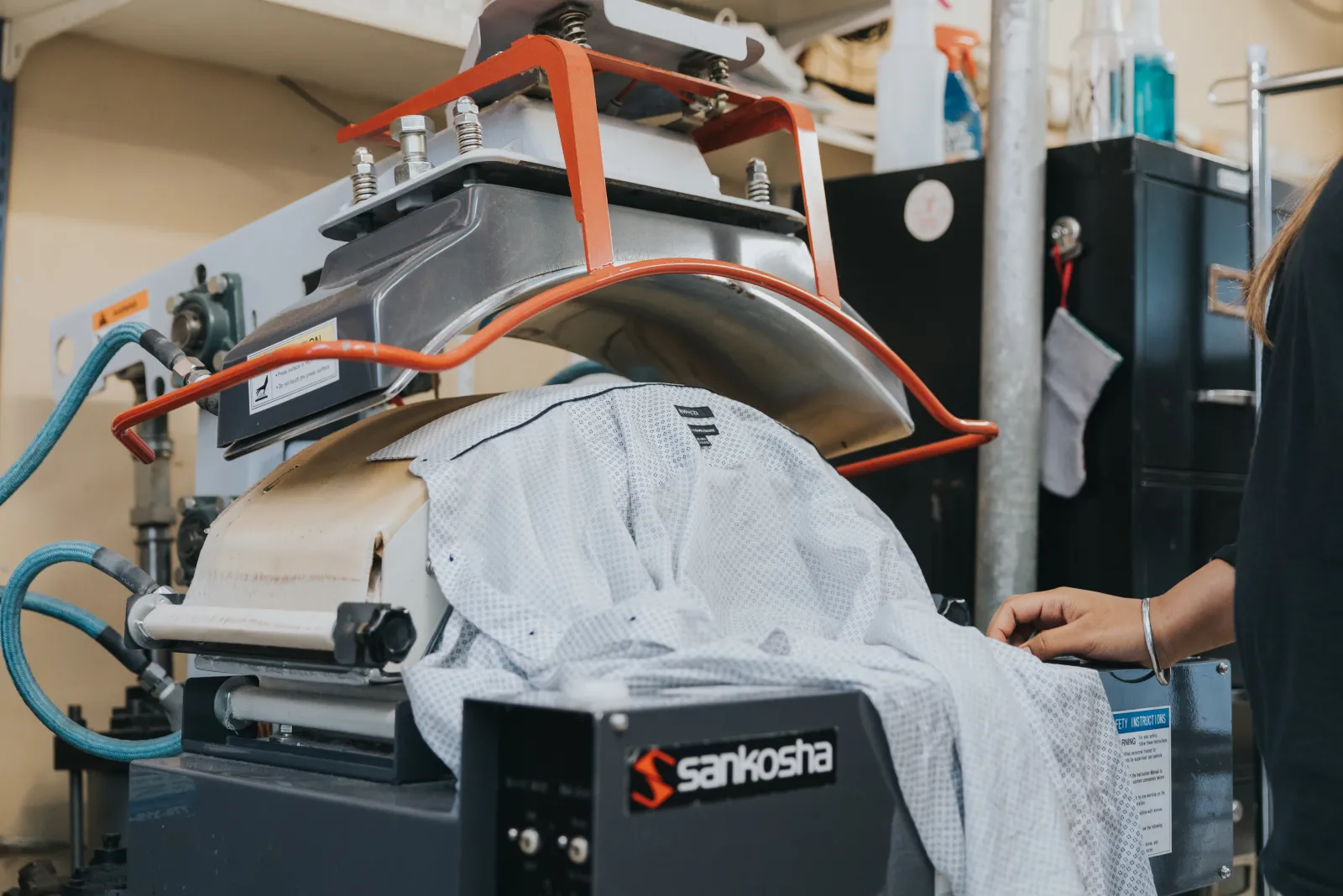 A dress shirt being finished on a professional Sankosha pressing machine at the Laundry Brothers facility.